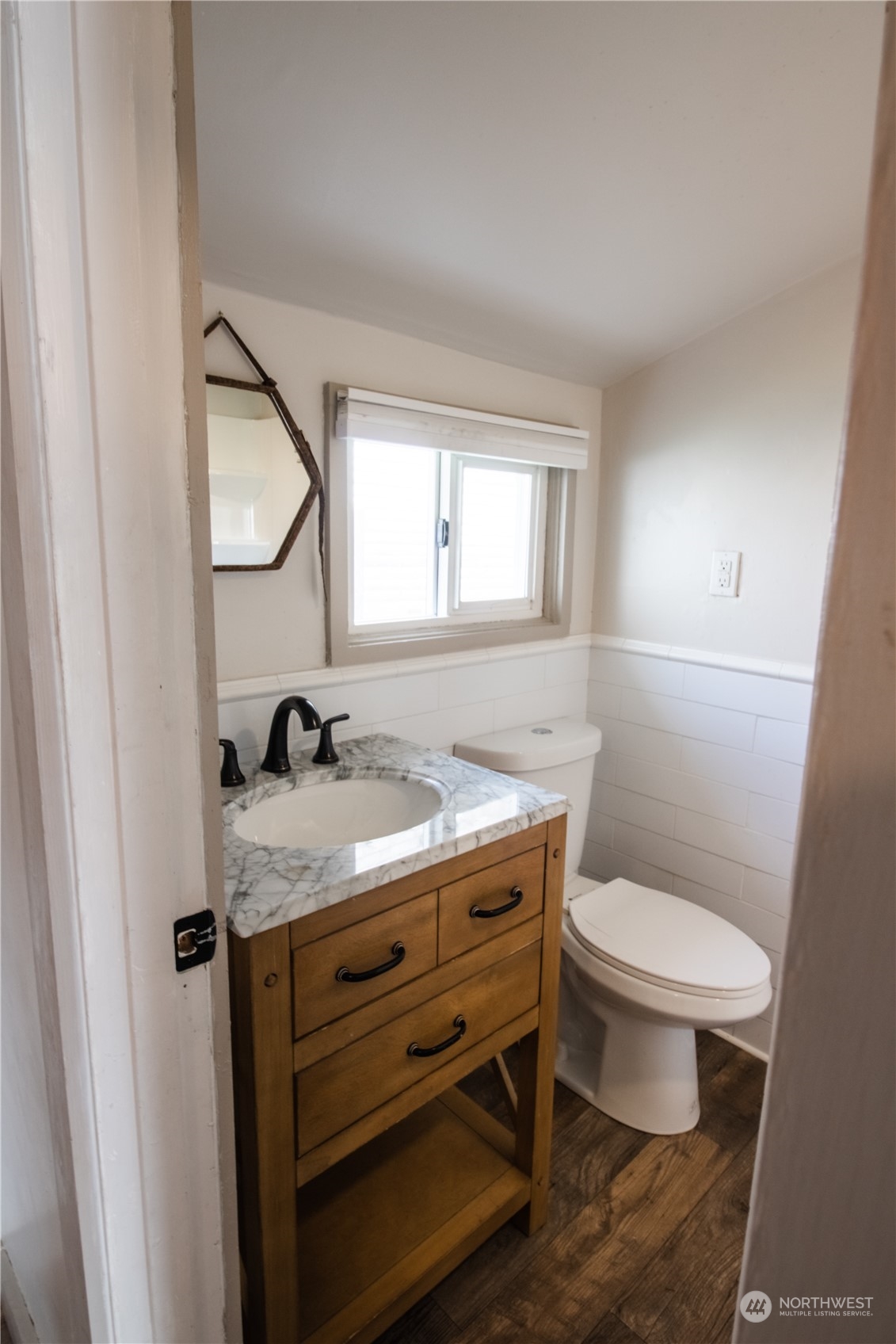 107 South M Street Aberdeen, WA 98520 - Photo 11 of 24 a bathroom with a granite countertop toilet a sink and a mirror