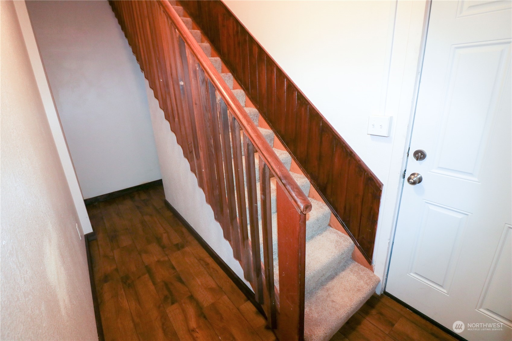 107 South M Street Aberdeen, WA 98520 - Photo 13 of 24 a view of staircase with wooden floor and white door