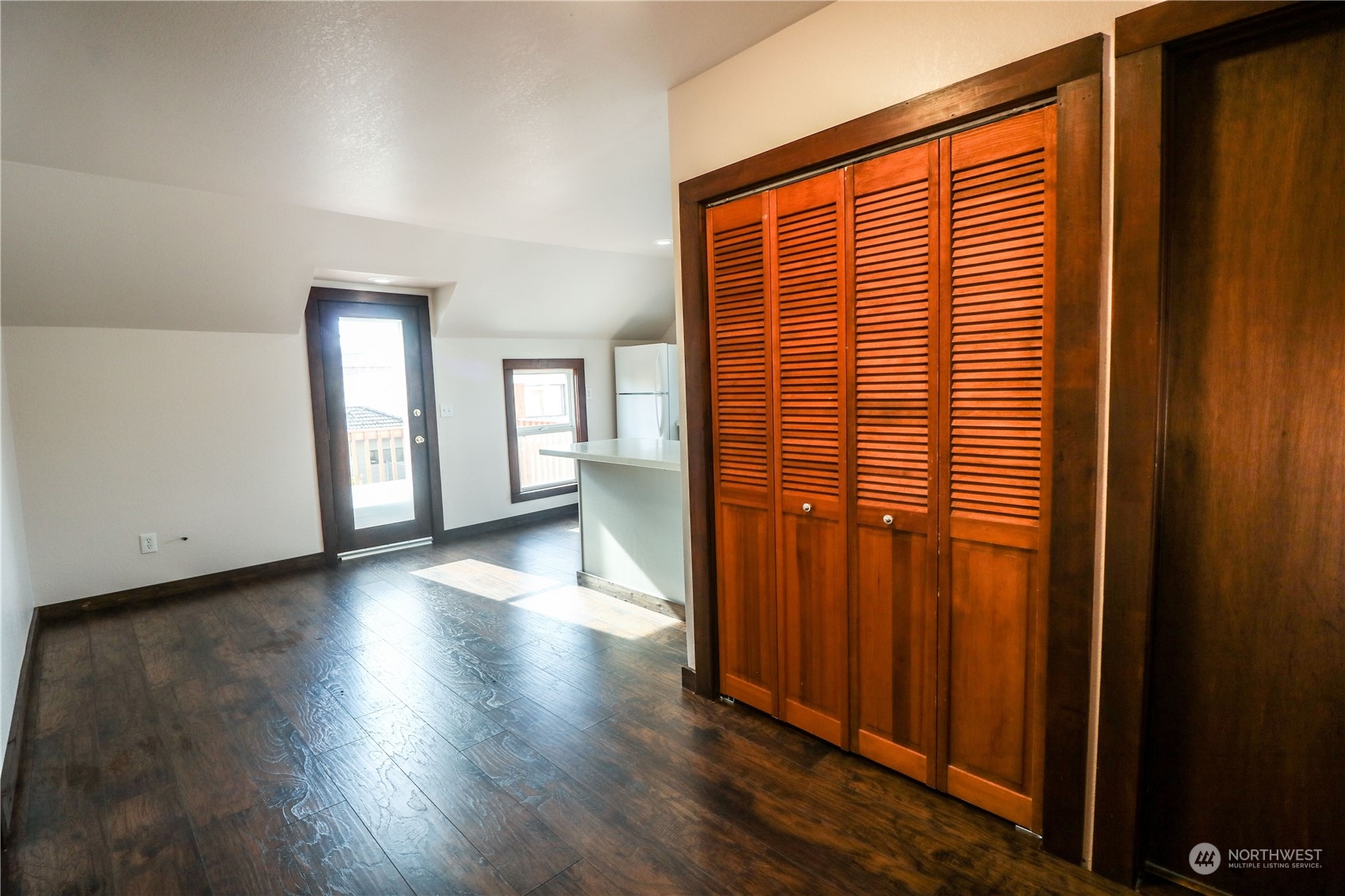 107 South M Street Aberdeen, WA 98520 - Photo 15 of 24 an empty room with wooden floor and windows