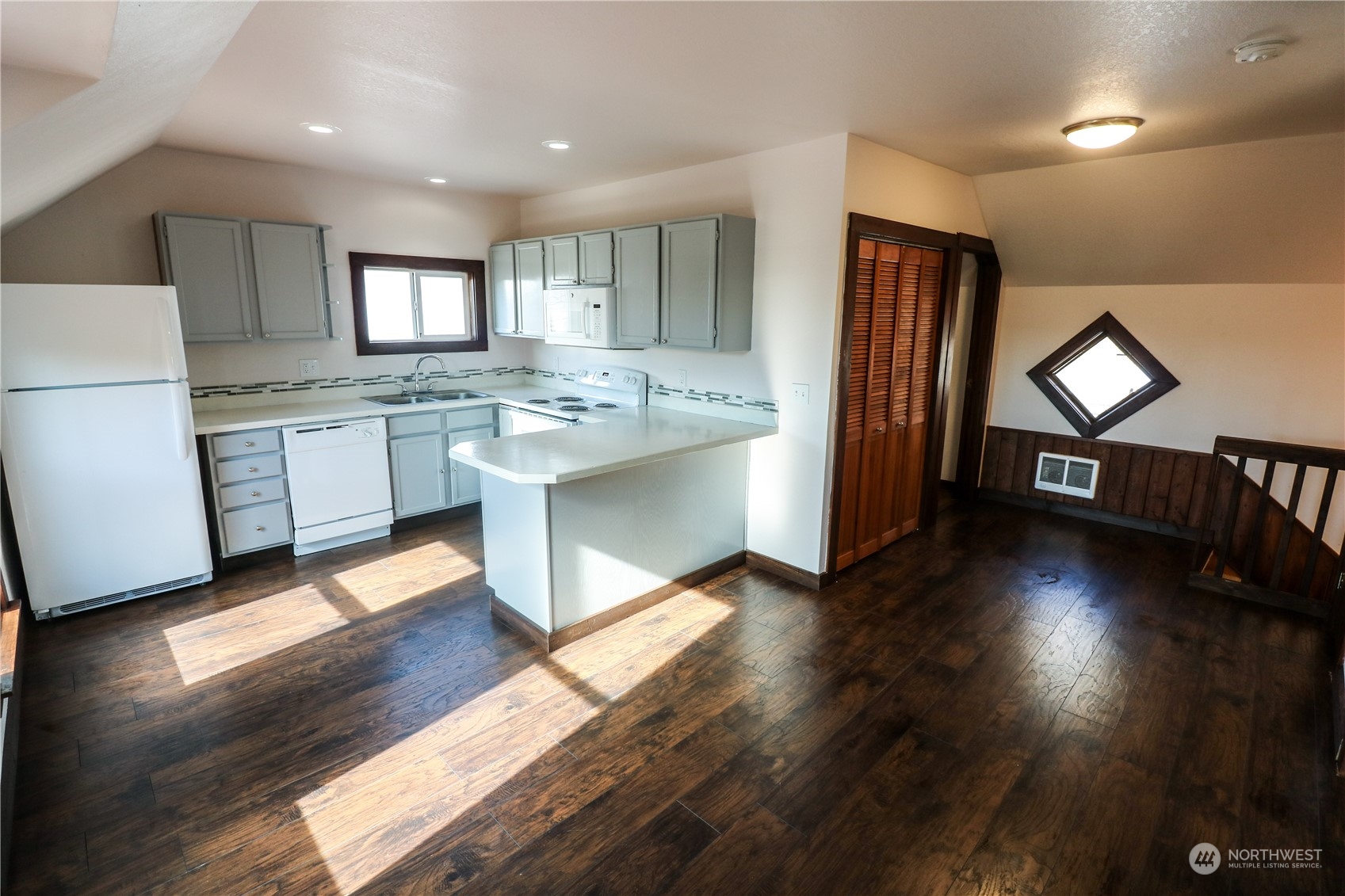 107 South M Street Aberdeen, WA 98520 - Photo 16 of 24 a kitchen with counter top space and wooden floor