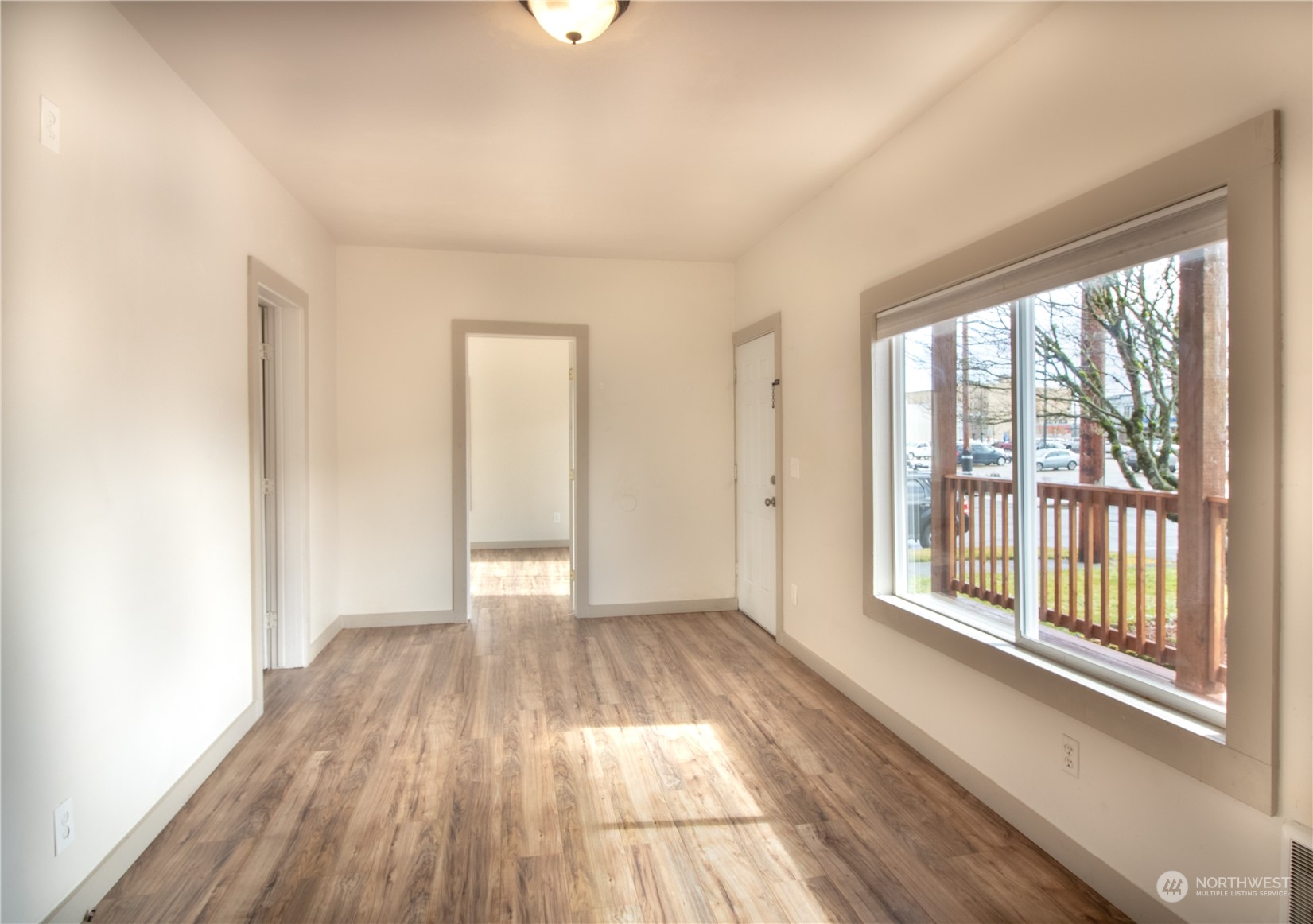 107 South M Street Aberdeen, WA 98520 - Photo 3 of 24 a view of an empty room with wooden floor and a window