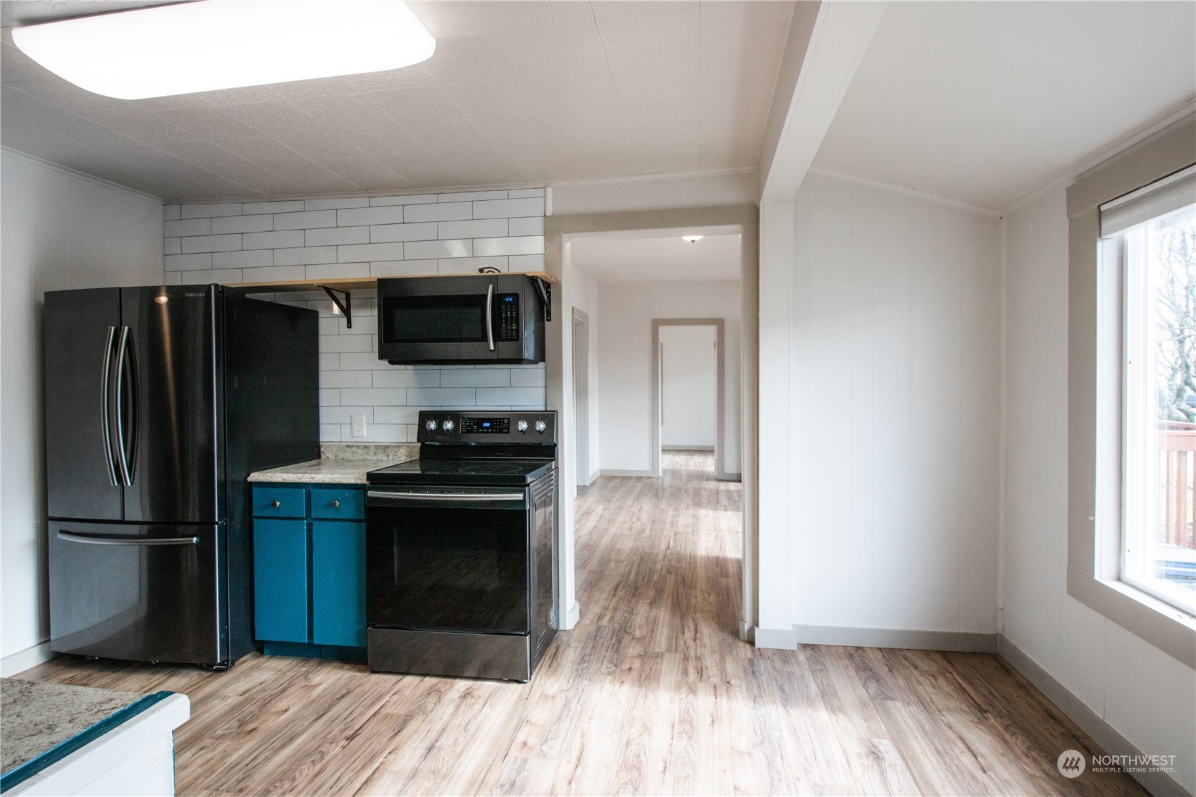107 South M Street Aberdeen, WA 98520 - Photo 6 of 24 a kitchen with a refrigerator and a stove top oven