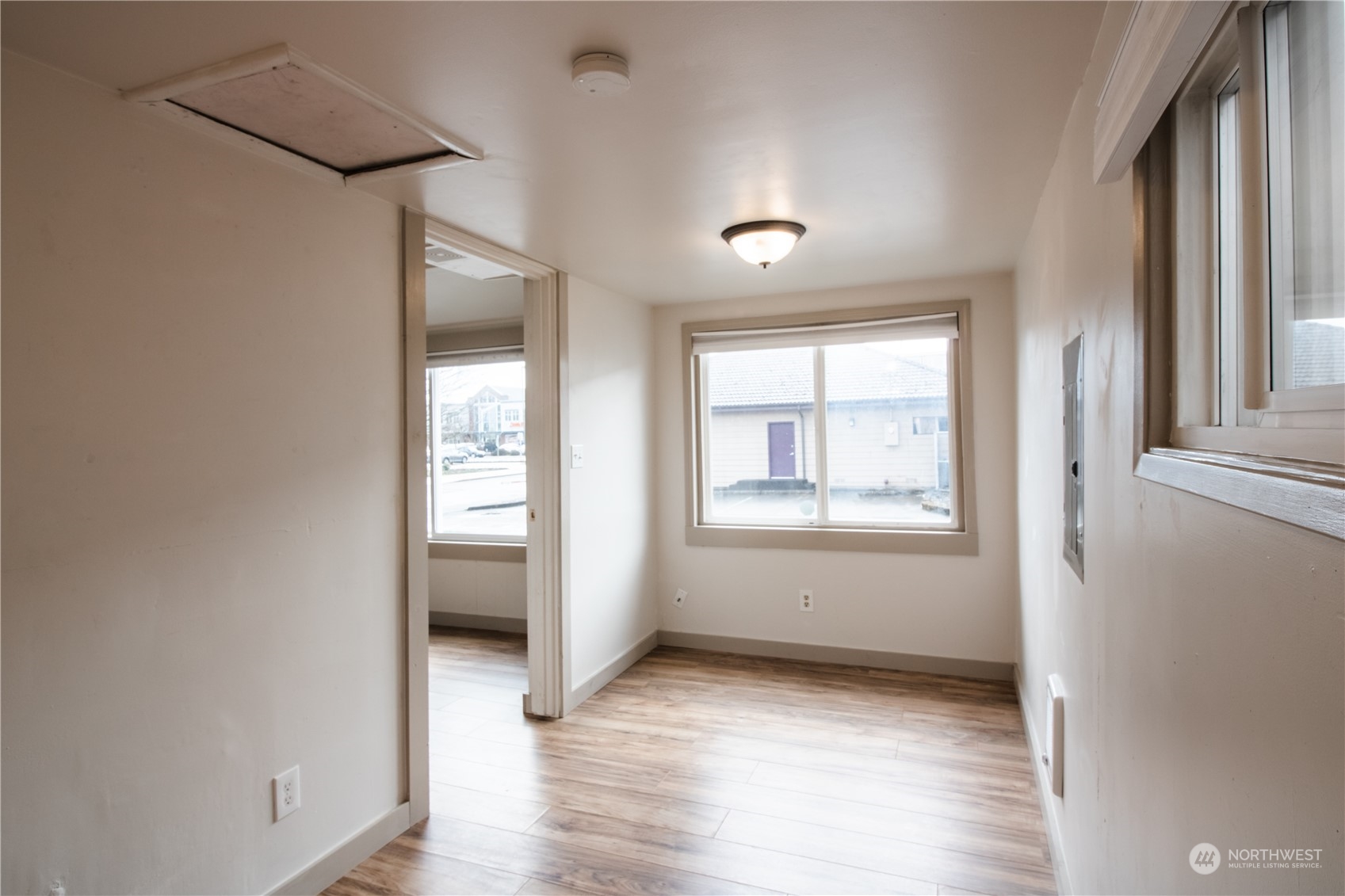 107 South M Street Aberdeen, WA 98520 - Photo 8 of 24 an empty room with wooden floor and windows