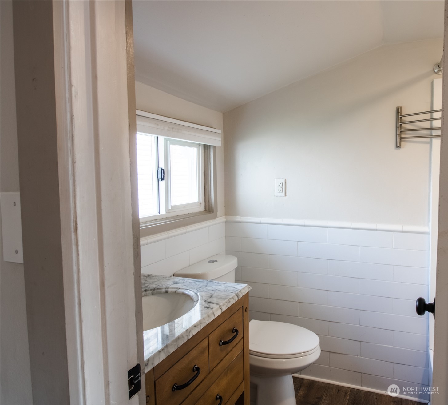 107 South M Street Aberdeen, WA 98520 - Photo 10 of 24 a bathroom with a granite countertop toilet a sink and a window