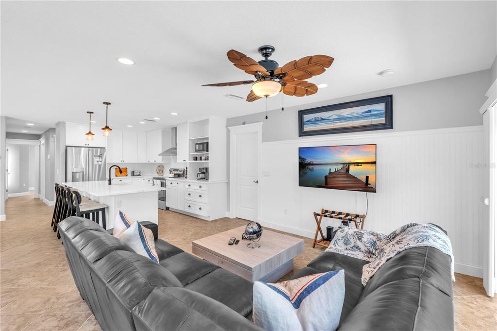 302 67th Street Holmes Beach, FL 34217 - Photo 12 of 38 a living room with furniture kitchen view and a flat screen tv