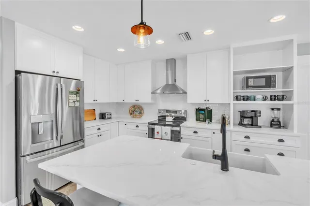 a kitchen with white cabinets and white appliances