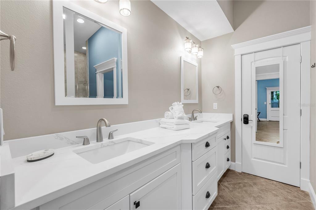 302 67th Street Holmes Beach, FL 34217 - Photo 19 of 38 a bathroom with a sink and a mirror