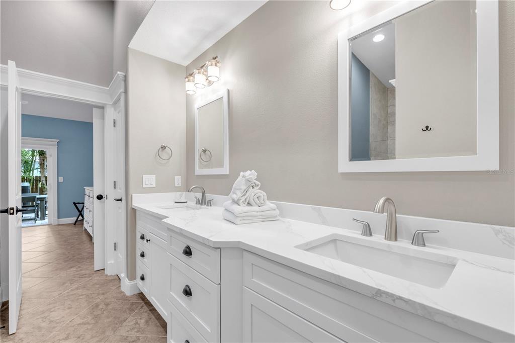 302 67th Street Holmes Beach, FL 34217 - Photo 20 of 38 a bathroom with a double vanity sink mirror and