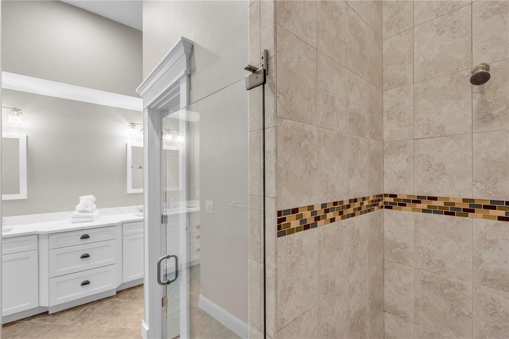 302 67th Street Holmes Beach, FL 34217 - Photo 21 of 38 a bathroom with a shower and a mirror