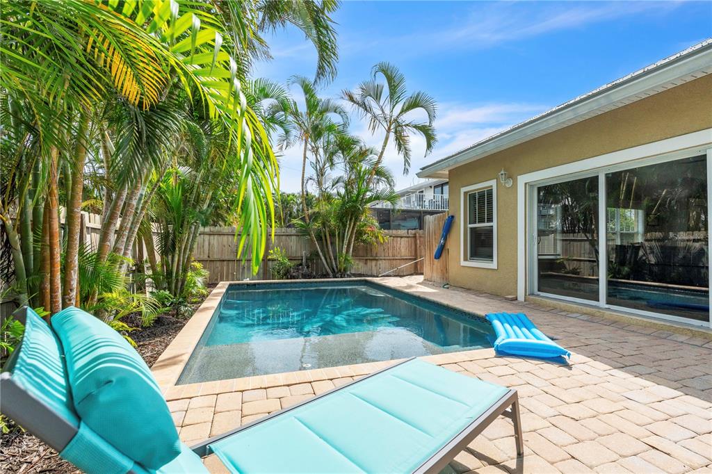 302 67th Street Holmes Beach, FL 34217 - Photo 30 of 38 a view of a backyard with plants and a patio