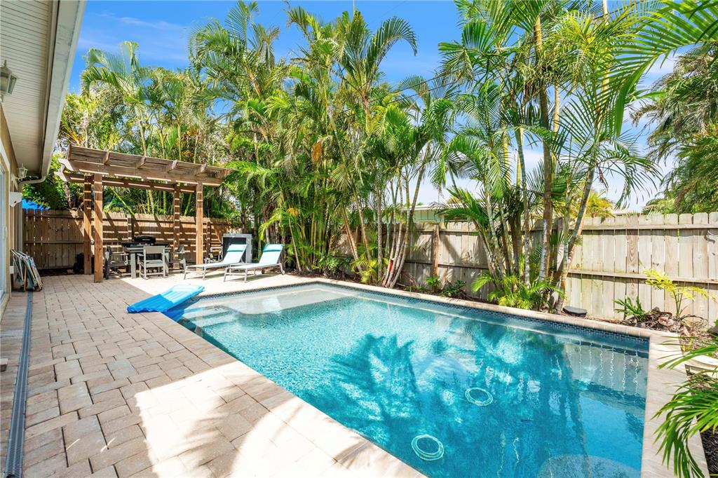 302 67th Street Holmes Beach, FL 34217 - Photo 32 of 38 a view of swimming pool with a yard