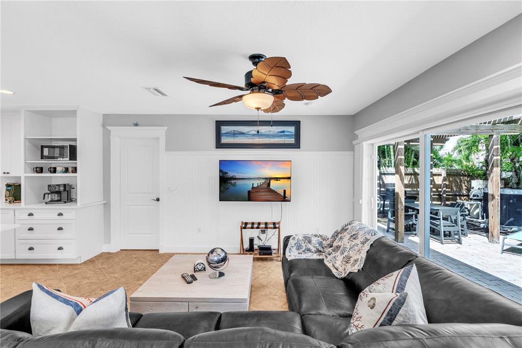 302 67th Street Holmes Beach, FL 34217 - Photo 10 of 38 a living room with furniture and a flat screen tv