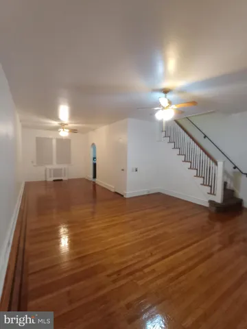 a view of a room with wooden floor