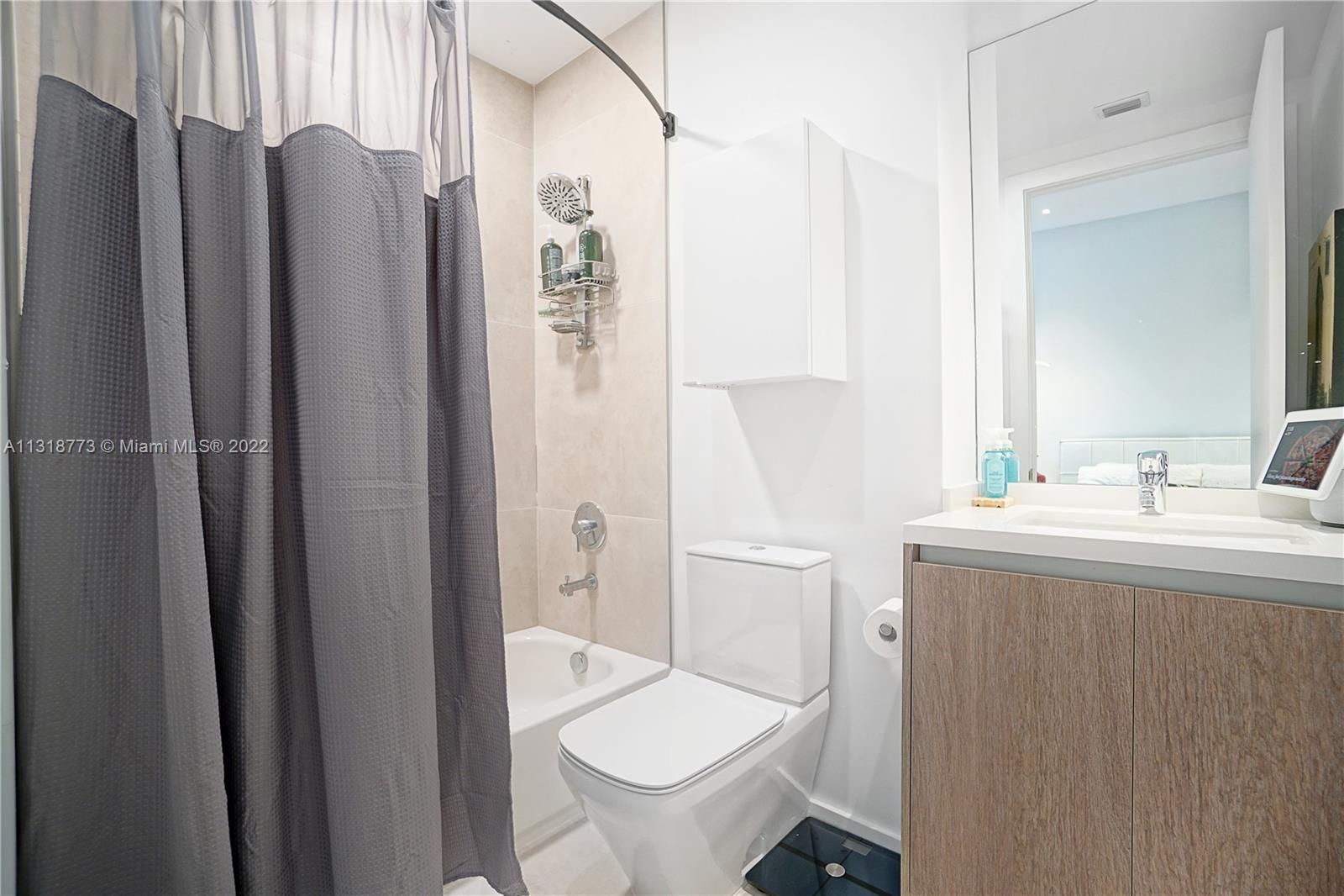 3156 Southwest 27th Avenue, Unit 101 Miami, FL 33133 - Photo 14 of 29 a bathroom with a sink toilet and shower