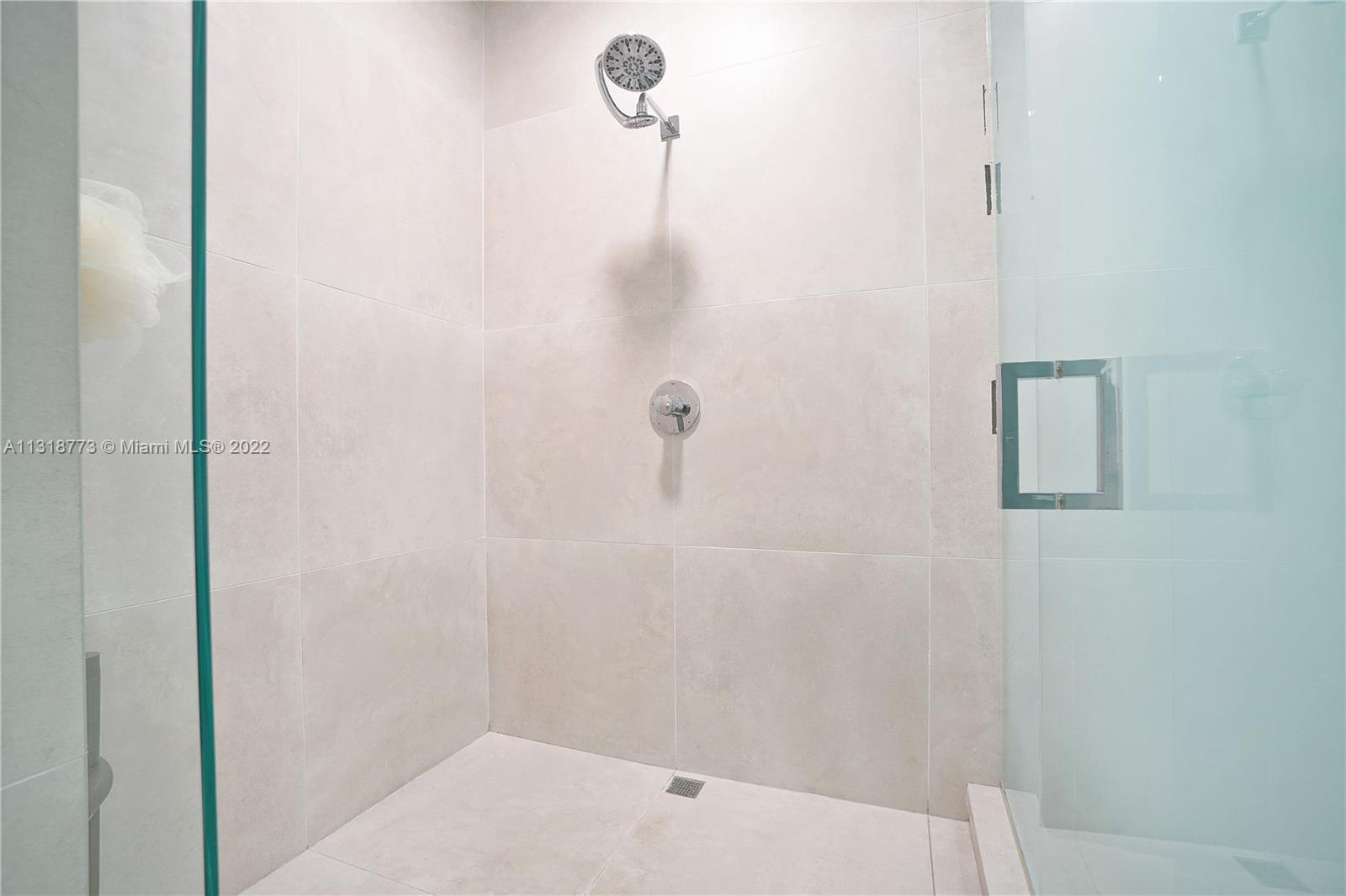 3156 Southwest 27th Avenue, Unit 101 Miami, FL 33133 - Photo 18 of 29 a bathroom with a shower