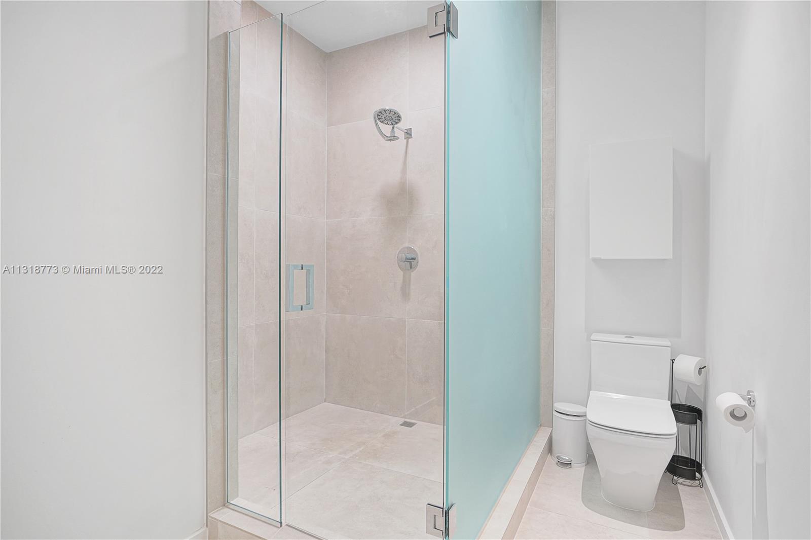 3156 Southwest 27th Avenue, Unit 101 Miami, FL 33133 - Photo 20 of 29 a bathroom with a shower and toilet
