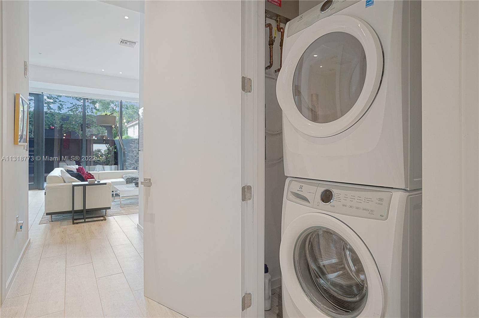 3156 Southwest 27th Avenue, Unit 101 Miami, FL 33133 - Photo 21 of 29 a view of a bedroom with washer and dryer