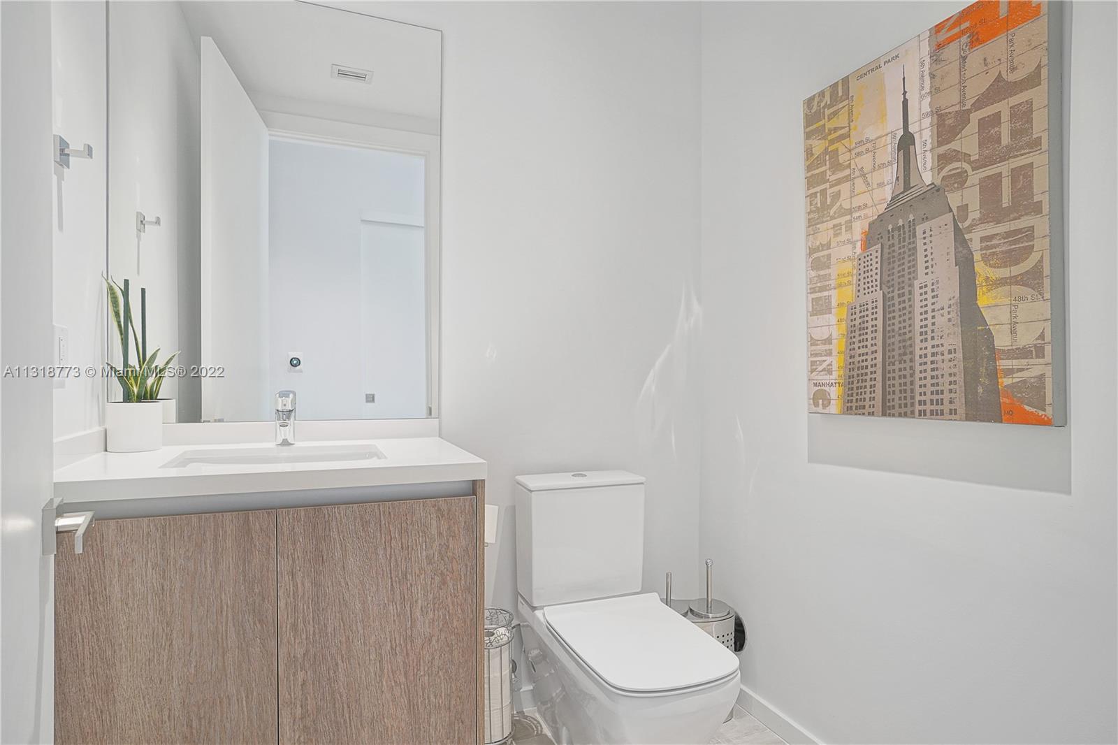 3156 Southwest 27th Avenue, Unit 101 Miami, FL 33133 - Photo 22 of 29 a bathroom with a sink and a toilet