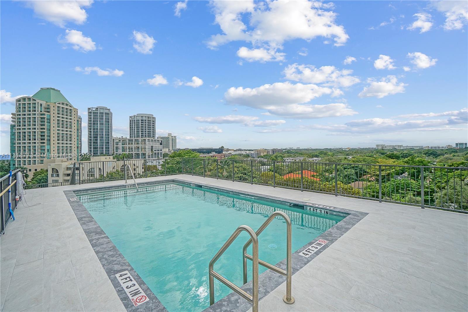3156 Southwest 27th Avenue, Unit 101 Miami, FL 33133 - Photo 24 of 29 a view of swimming pool with a back yard