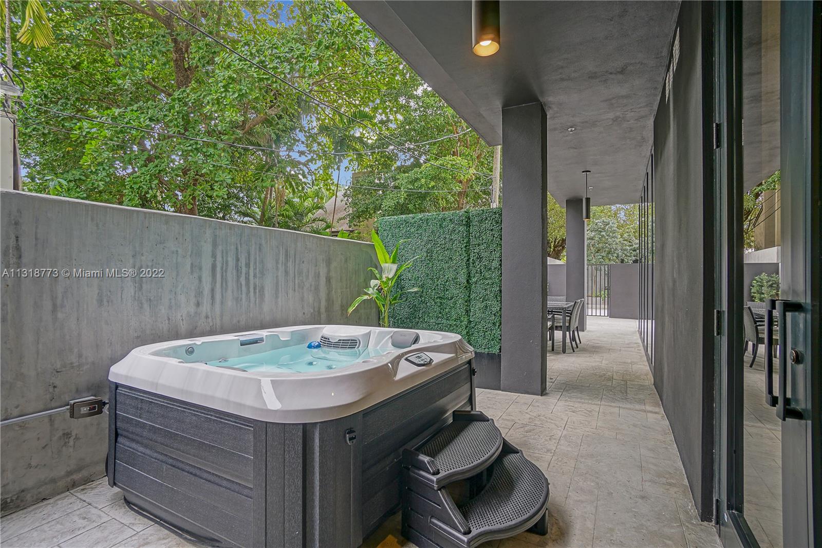 3156 Southwest 27th Avenue, Unit 101 Miami, FL 33133 - Photo 10 of 29 a view of a jacuzzi with backyard