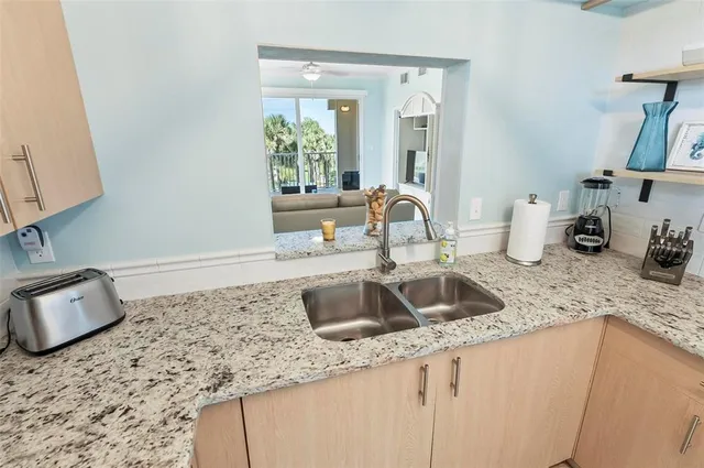 a kitchen with sink and mirror