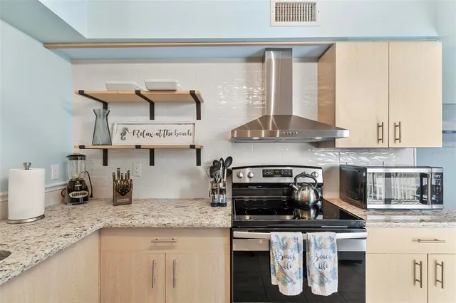 a kitchen with stainless steel appliances granite countertop a stove and a sink