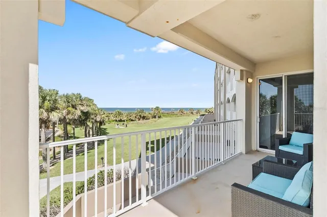 a view of a balcony with couches potted plants and sky view