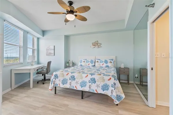 a bedroom with a bed and a chandelier