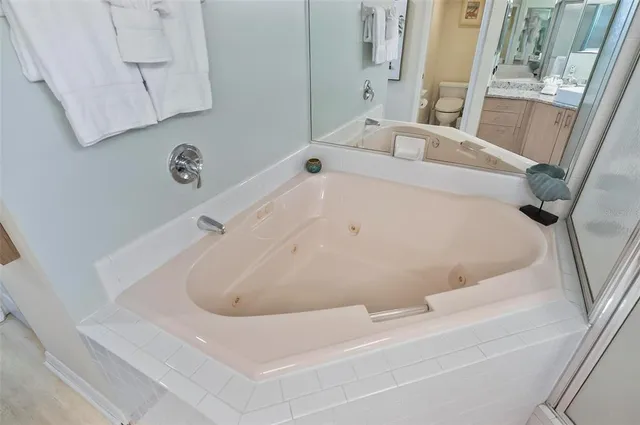 a bath tub sitting next to a white sink