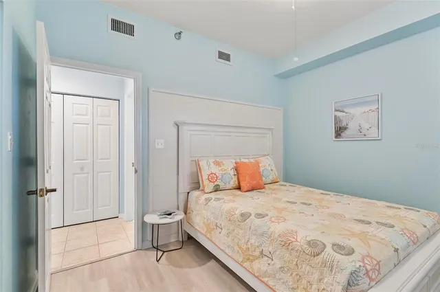 a bedroom with a bed and painting on the wall