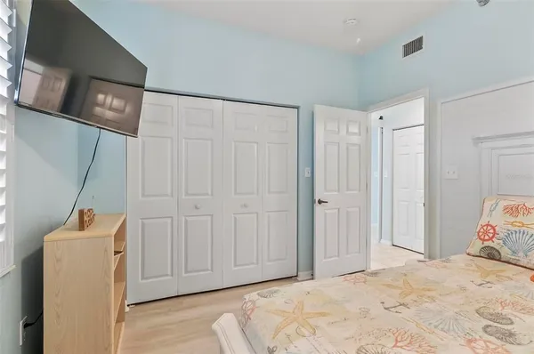 a view of a room with wooden floor and closet