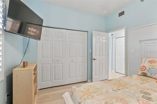a view of a room with wooden floor and closet