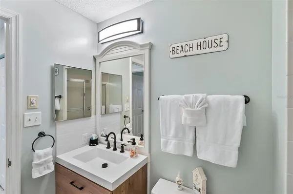 a bathroom with a sink mirror and vanity
