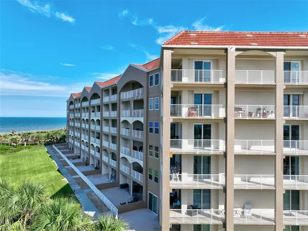 a front view of a building with a yard