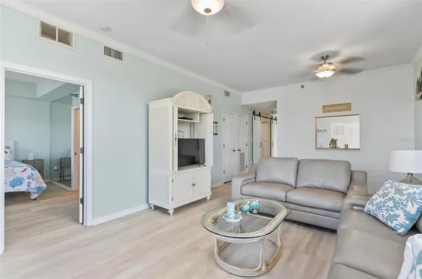 a living room with furniture a rug and a chandelier