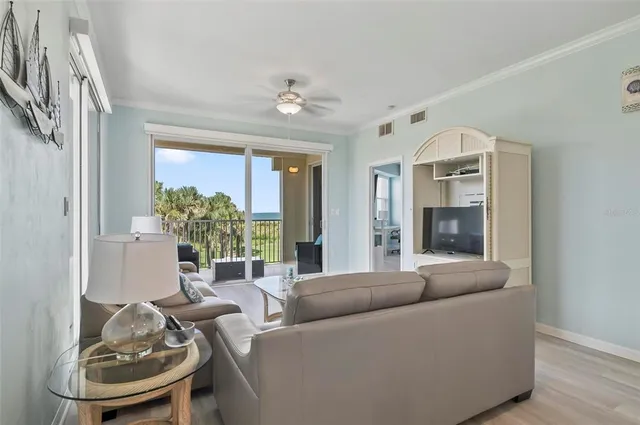 a living room with furniture and a potted plant
