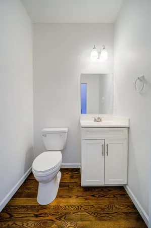 a bathroom with a sink toilet and a mirror