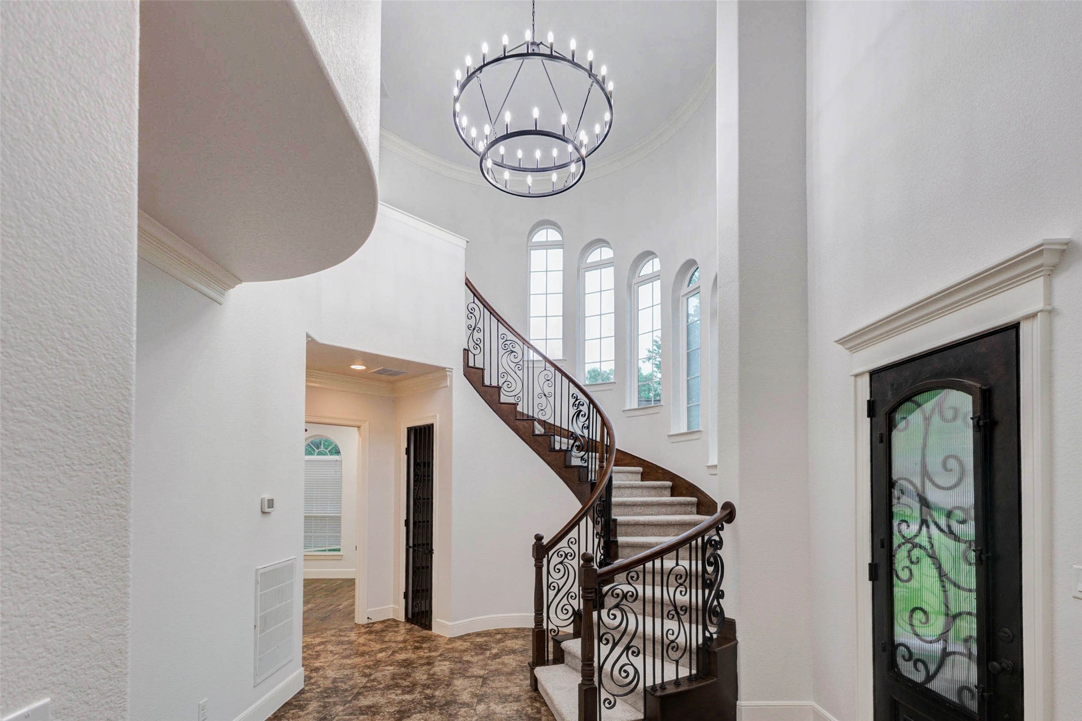 5327 Whitmore Fulshear, TX 77441 - Photo 5 of 50 This stunning entry welcomes you with a grand 2 story ceiling, beautiful tiered chandelier and curved staircase.
