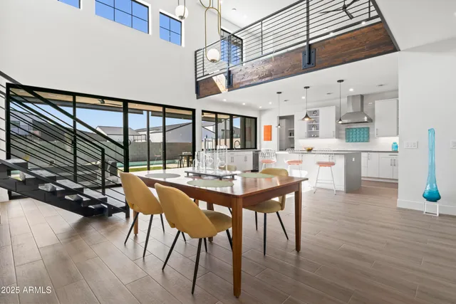 a kitchen with a refrigerator a stove and a sink with wooden floor