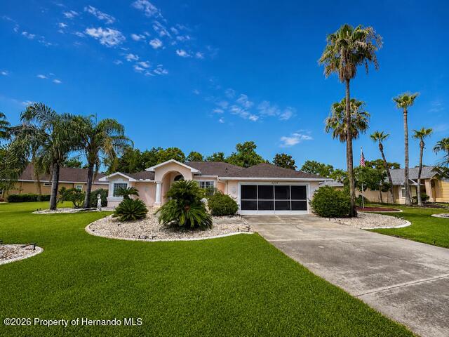 14219 Mansfield Road Spring Hill, FL 34609 - Photo 1 of 1 a front view of a house with a yard