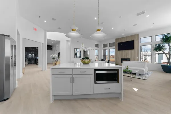 a kitchen with a sink and a stove top oven with wooden floor