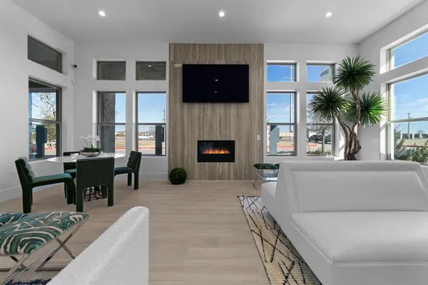 a living room with furniture a fireplace and a flat screen tv