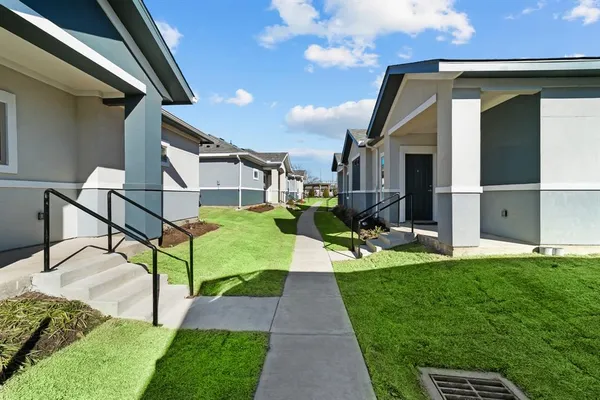 a front view of house with yard and outdoor seating