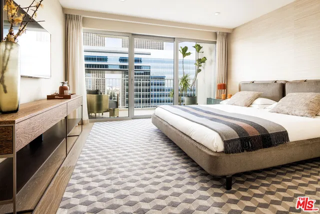 a bedroom with a large bed and a large window