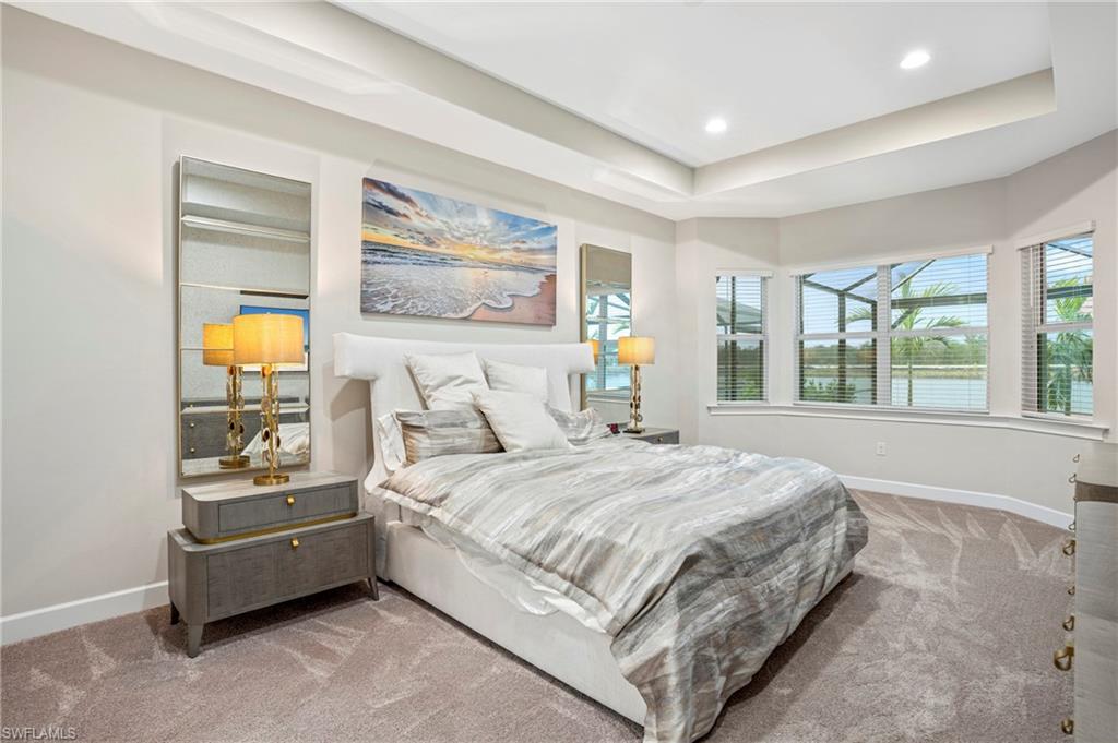 8795 Calypso Court Naples, FL 34113 - Photo 12 of 49 a bedroom with a bed and glass window