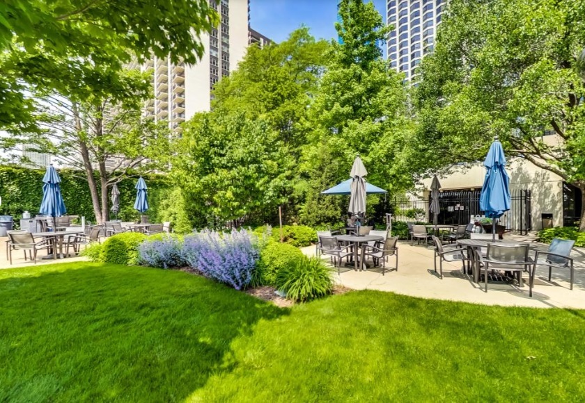 155 North Harbor Drive, Unit 2011 Chicago, IL 60601 - Photo 39 of 45 a view of a patio with table and chairs potted plants and large tree