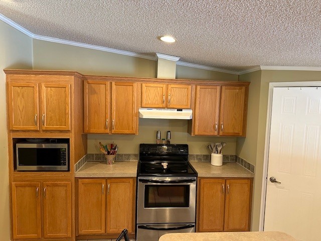 503 Howell Hill Road Kelso, TN 37348 - Photo 17 of 33 a kitchen with stainless steel appliances a stove a microwave and a refrigerator