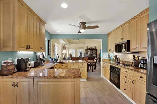 a kitchen with stainless steel appliances granite countertop a stove and refrigerator