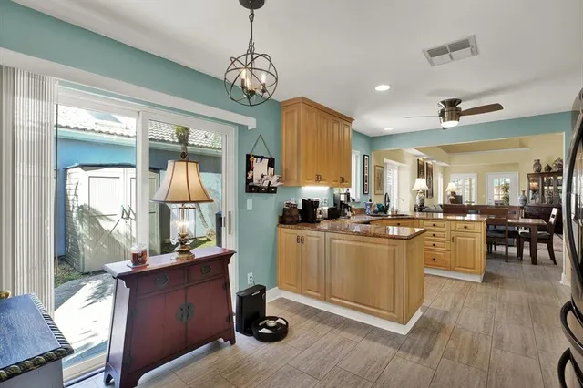 a kitchen with kitchen island a sink appliances and cabinets