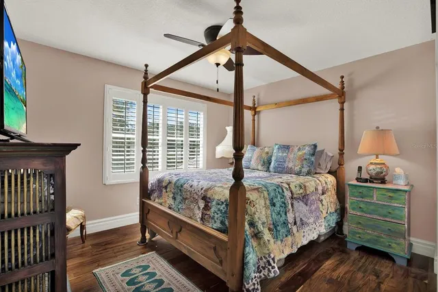 a bedroom with a bed and a mirror